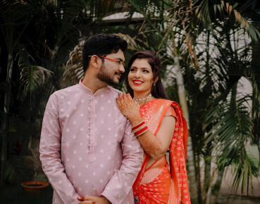 Anand and Kavitha in traditional Indian wedding attire at their wedding in Kochi