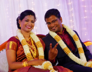 Ansu and Bejoy wearing wedding garlands at their traditional wedding in Kochi, planned by WDC wedding planners