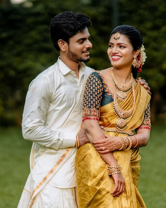 Bride in a yellow silk saree and groom in white at a wedding organised by WDC wedding planners in Chennai