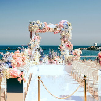 Beach destination wedding aisle with a floral arch arranged by WDC wedding planners