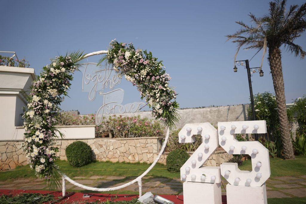 25th anniversary celebration with a floral arch, organised by our social event management team