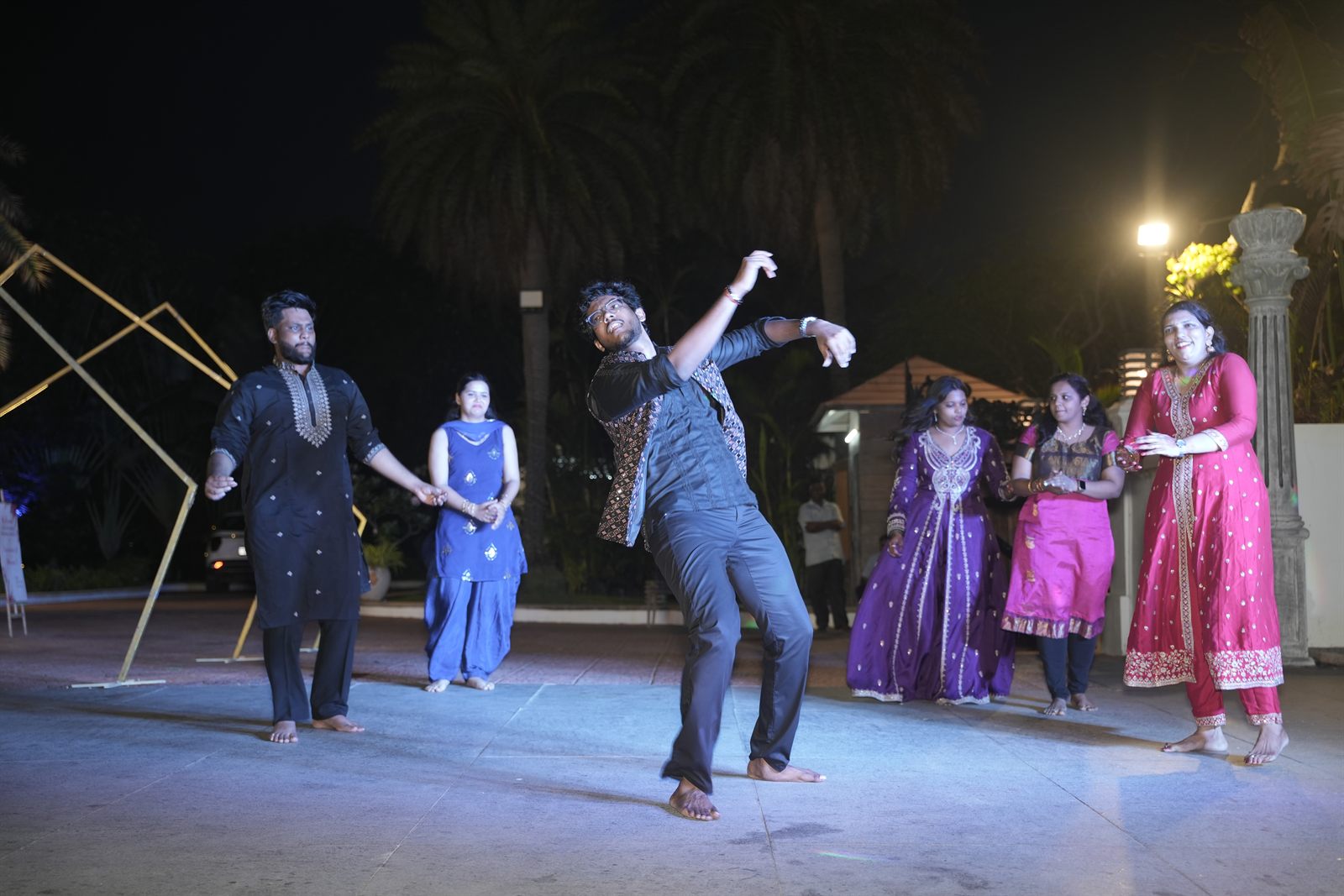 Guests dancing to live music on an open-air dance floor at a 25th anniversary celebration