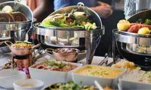 Wedding catering buffet with salads, fruit and hot dishes in chafing dishes