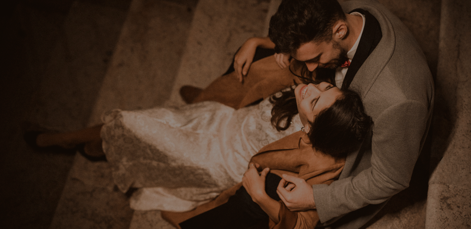 Romantic couple portrait on stone steps captured by our wedding photographers
