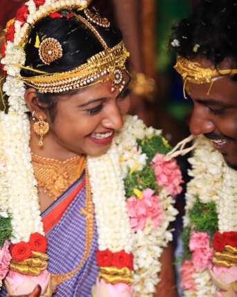 South Indian bride and groom wearing jasmine garlands at a traditional wedding by WDC wedding planners